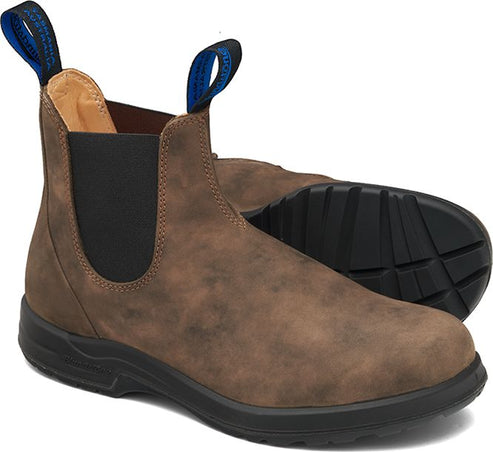 A pair of brown Chelsea-style boots with black soles and blue pull loops.