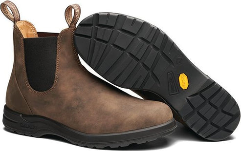 Chelsea boot in brown suede leather with elastic side panels, visible black sole, and looped pull tabs.