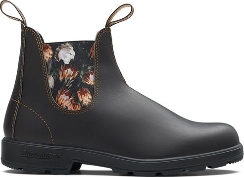 Dark brown ankle boot with floral side panel, pull tabs, and black sole.