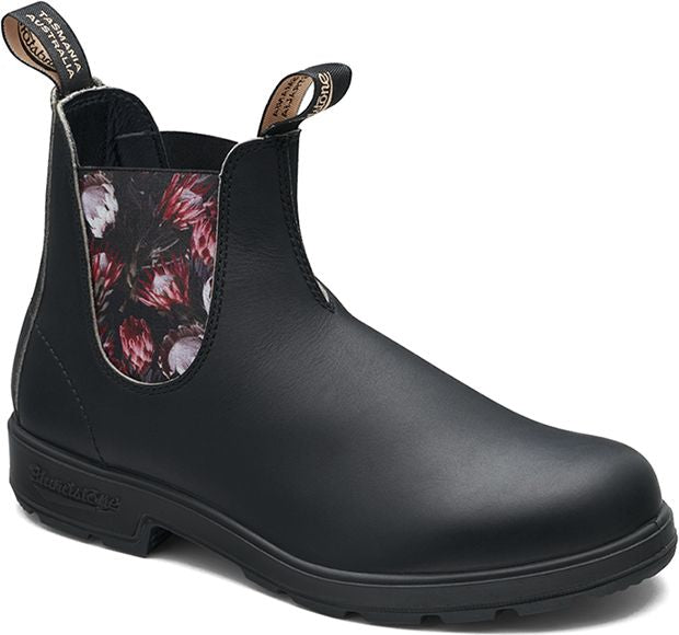 A black leather ankle boot with floral lining and pull loops.