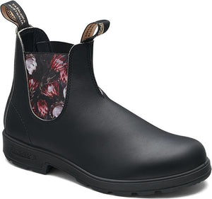 A black leather ankle boot with floral lining and pull loops.