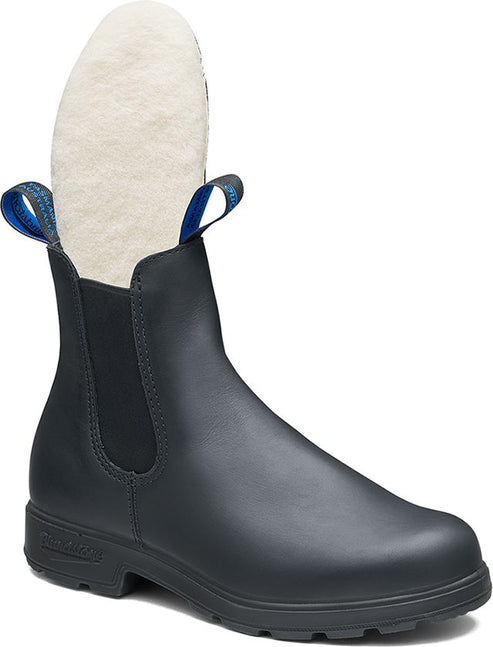 Black Chelsea boot with blue pull tabs and shearling lining.