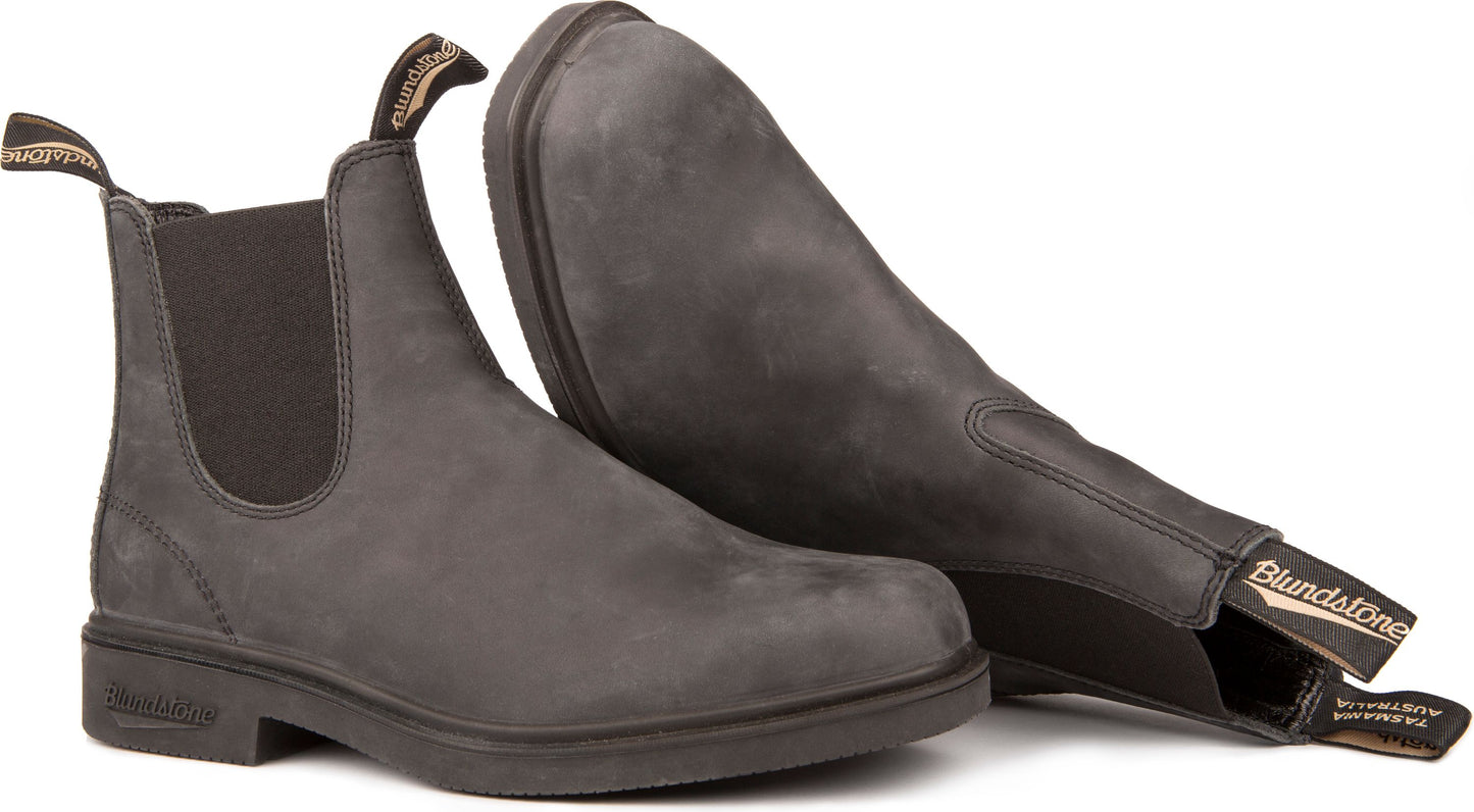 Two gray ankle boots, one standing and the other on its side showing the sole.