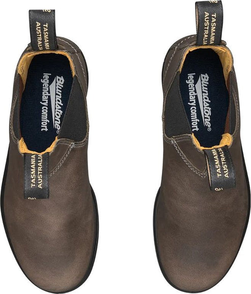 Overhead view of two matching brown ankle boots with black elastic side panels and pull-tabs, displaying interior text reading "Blundstone legendary comfort."