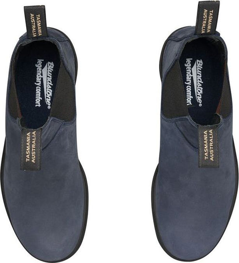 Top-down view of two blue suede ankle boots with black elastic side panels and pull loops labeled "TASMANIA AUSTRALIA" and  "Blundstone legendary comfort".