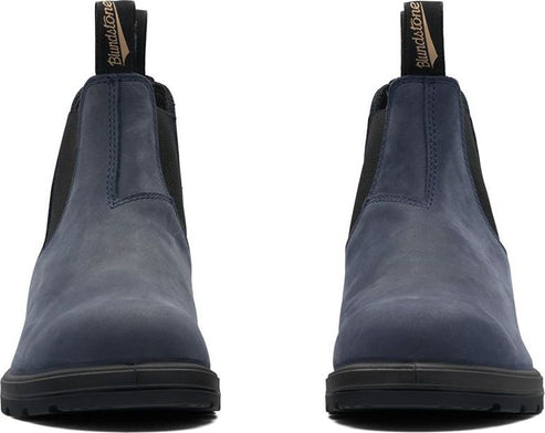 Pair of blue Chelsea-style boots with black soles.
