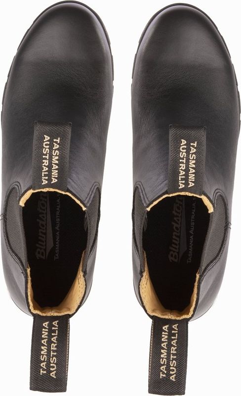 A pair of black leather Chelsea boots viewed from above.
