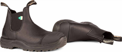 Two black leather work boots, one on its side.