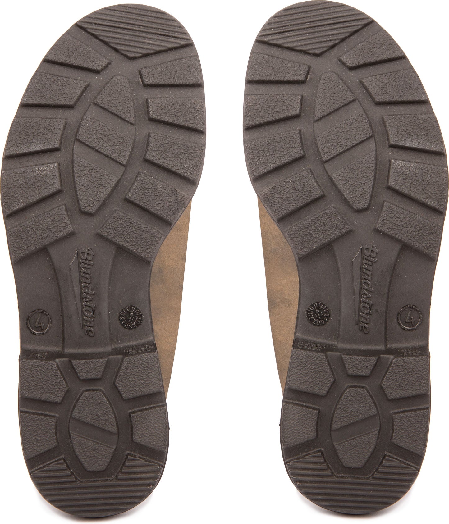 Bottoms of two brown boot soles displaying tread patterns.