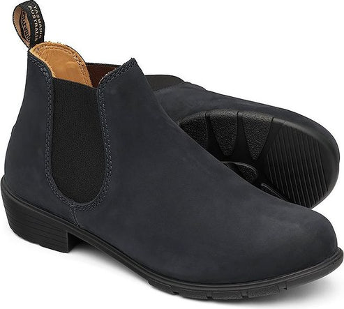 Two matte navy leather Chelsea boots, stacked heels, elastic side panels, soles visible.