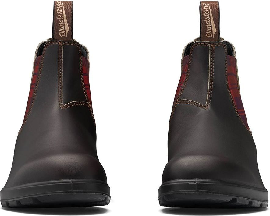 A pair of dark brown leather Chelsea boots with elasticated red and black plaid panels.