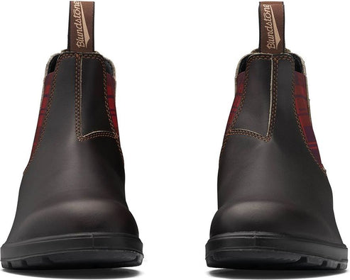 A pair of dark brown leather Chelsea boots with elasticated red and black plaid panels.