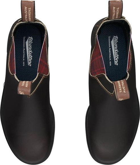 Two dark brown leather Chelsea boots are displayed from an aerial viewpoint with the labels and tartan interior visible.