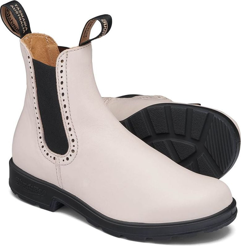 White leather ankle boot with black sole and elastic side panels.