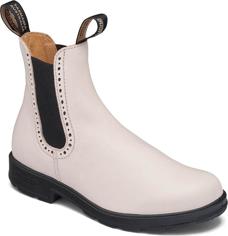 White leather ankle boot with a black sole and heel tab, and black elastic side panels with decorative perforations.