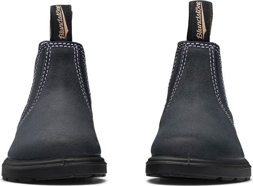 Close-up of two dark gray suede Chelsea boots with a beige pull tab.
