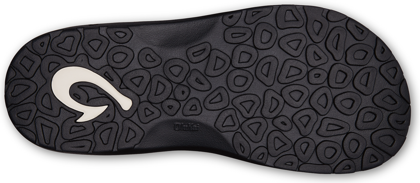 The sole of a black sandal with a textured design and a white hook-shaped logo.