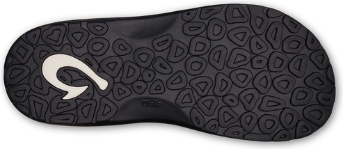 The sole of a black sandal with a textured design and a white hook-shaped logo.