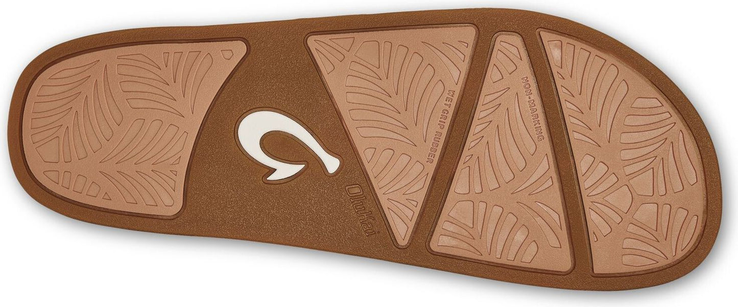 Brown sandal sole with leaf pattern and white logo.