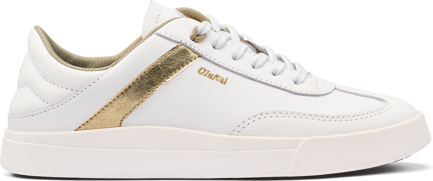 A white sneaker with gold accent.