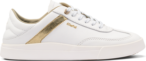 A white sneaker with gold accent.