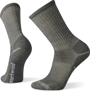 Two wool socks in a neutral gray color. They feature ribbed detailing and text reading "smartwool" on the side of one sock.