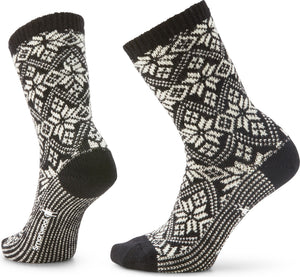 Two black crew socks with white snowflake pattern.
