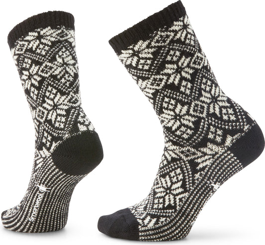 Two black crew socks with white snowflake pattern.