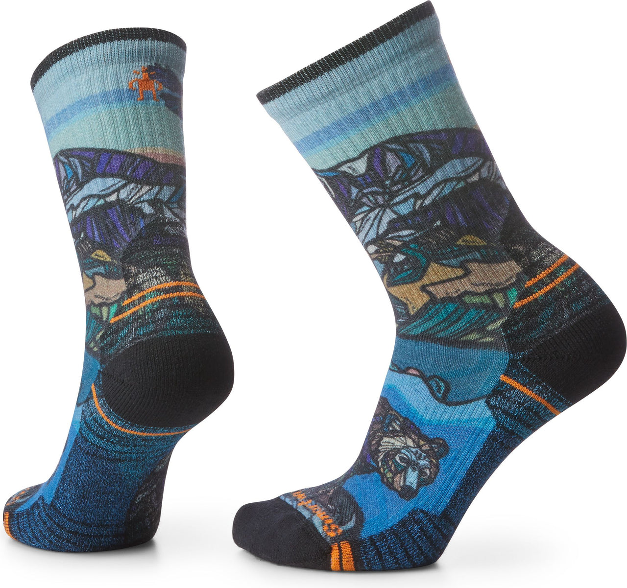 Two socks with a landscape design featuring mountains, water, and a bear.