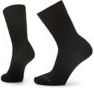 Two black crew socks, one upright, one on a foot.