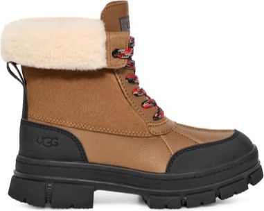Tan-colored lug-soled ankle boot with shearling cuff and red-and-black round laces.