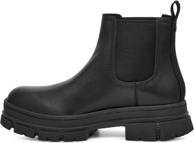 Black Chelsea boot with elastic side panels and a thick, lugged sole.