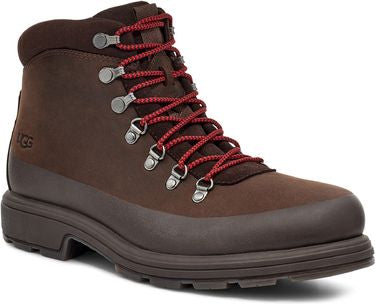 A brown leather hiking boot with red laces and metal eyelets.