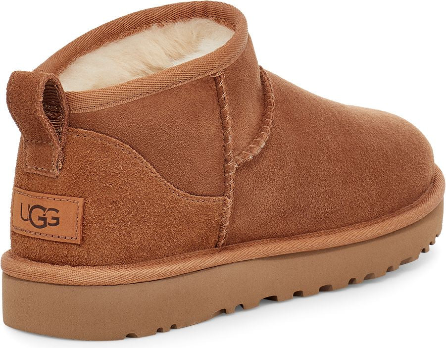 Brown ankle boot with suede-like texture, low profile sole and a pull loop on the heel with the letters "UGG".