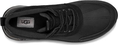 Overhead shot of a shoe with laces and a tag that says UGG