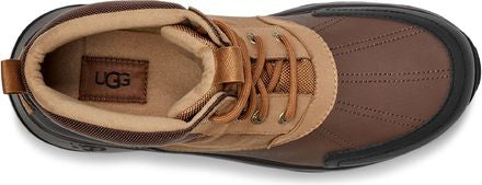 A brown boot with tan laces and a black sole, seen from above.