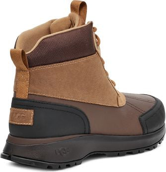 Side view of a tan ankle boot with a black sole and black paneling, featuring a lace-up closure and pull tabs at the back.