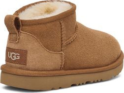 Toddler brown suede short boot with loop and sheepskin lining; "UGG" tag is visible on heel.