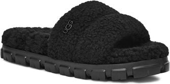 A black slipper with a thick, fuzzy upper and a chunky, lugged sole.