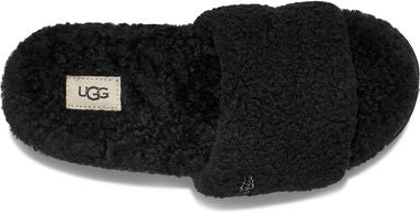Black slipper with a light beige rectangular patch on the side bearing three letters.