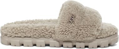 Fluffy slip-on sandal with a lug sole and UGG logo.