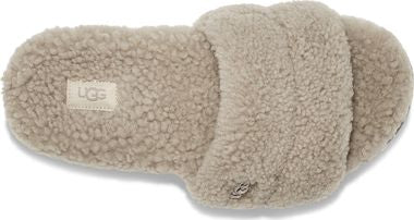 Beige slipper with overlapping fuzzy straps and a label that reads "UGG".