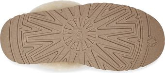 The bottom of a slipper, showing a textured rubber sole.
