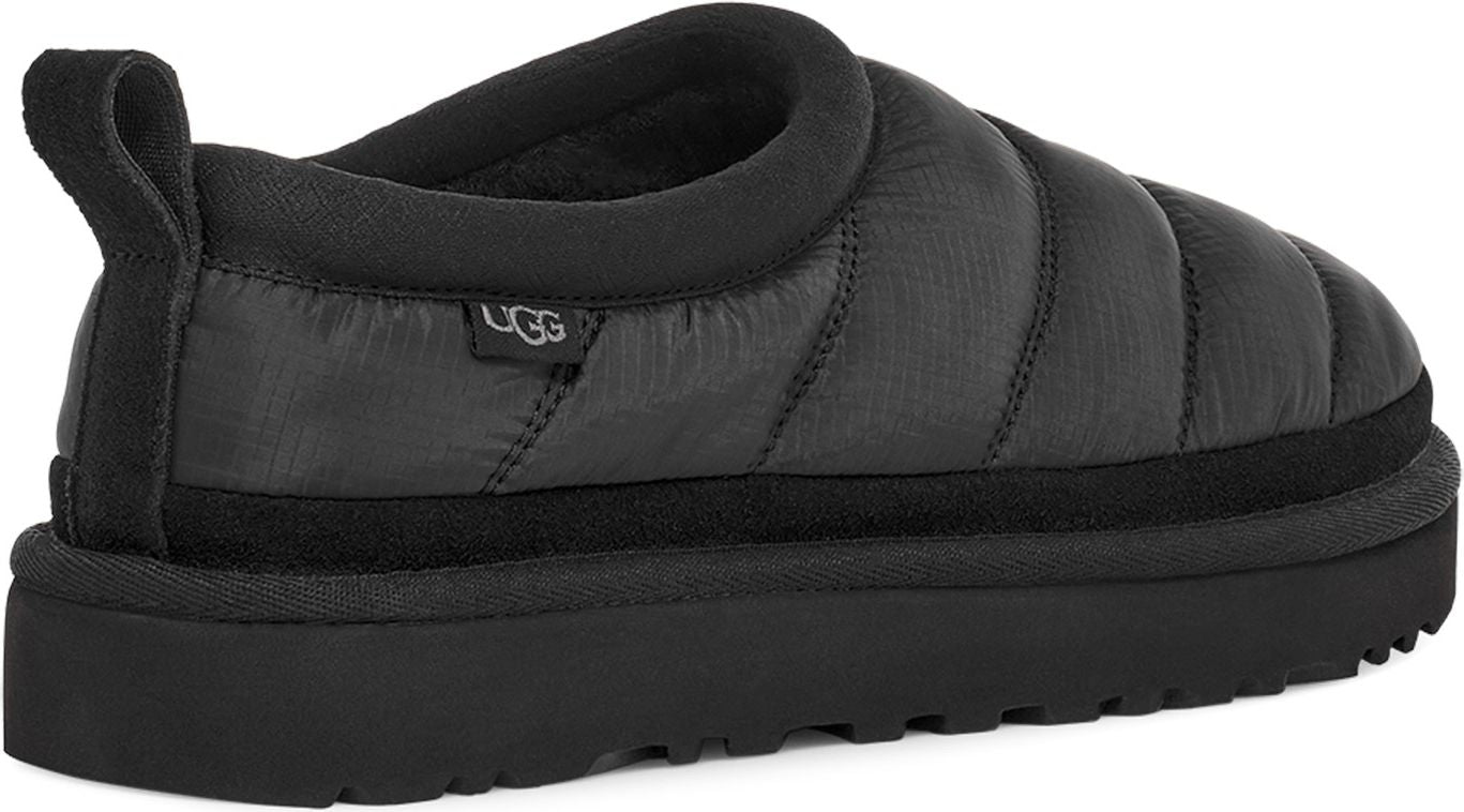 Black slip-on shoe with a thick sole and padded upper with a loop on the back.