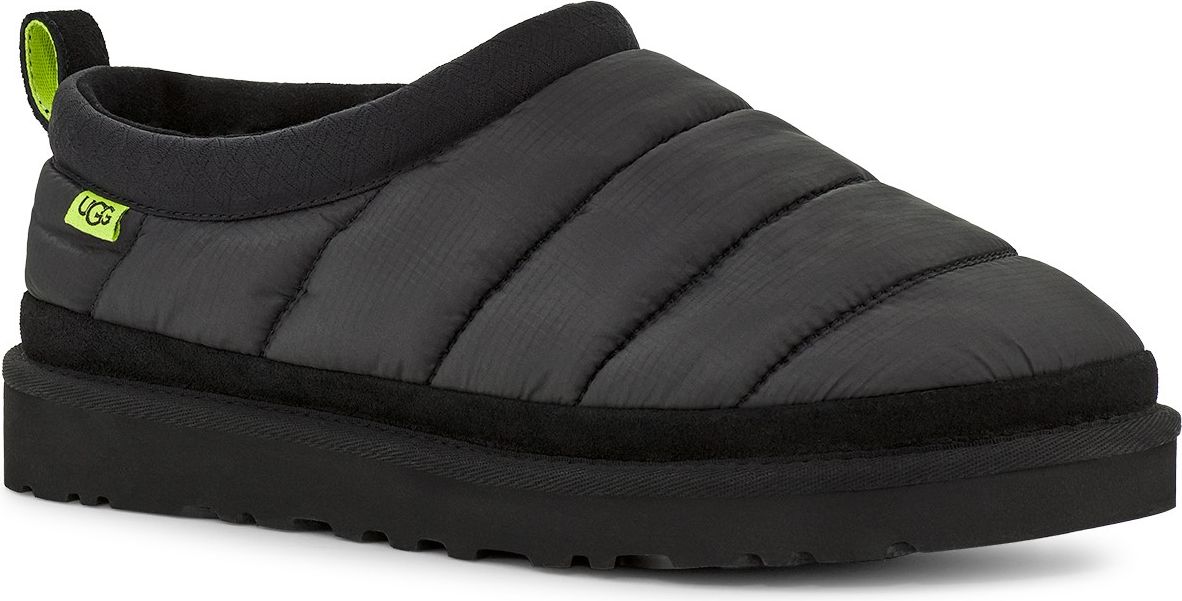 A charcoal-gray slipper with horizontal stitched lines is displayed, featuring a black platform sole, collar, heel pull, and a small lime green label.