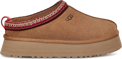 A brown slip-on shoe with a platform sole and a decorative trim around the opening.